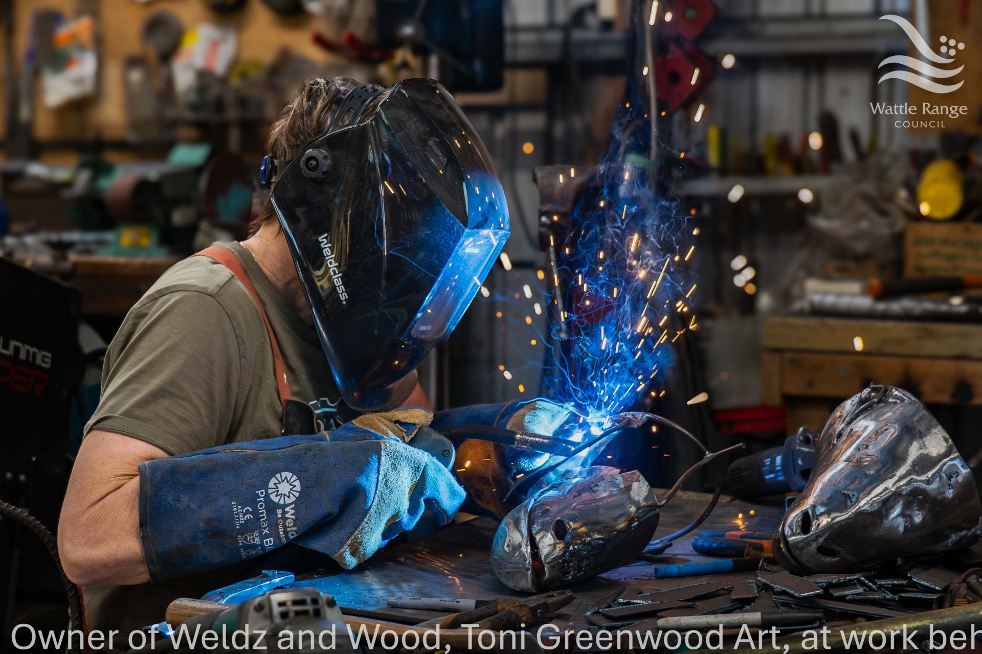 Owner of Weldz and Wood, Toni Greenwood Art, at work behind the welding Mask - Diana Vine